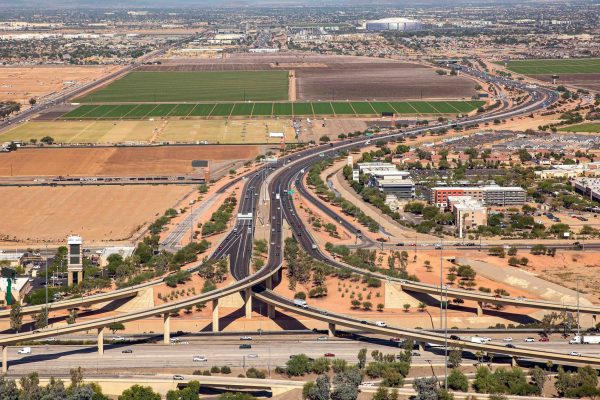 Aerial view lookng North at Interstate 10 in the foreground and up the Loop 101 at the interchange of the two freeways