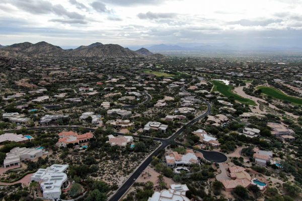 Aerial view of upscale luxury homes with dry landscape mountain and desert in Scottsdale, Phoenix, Arizona