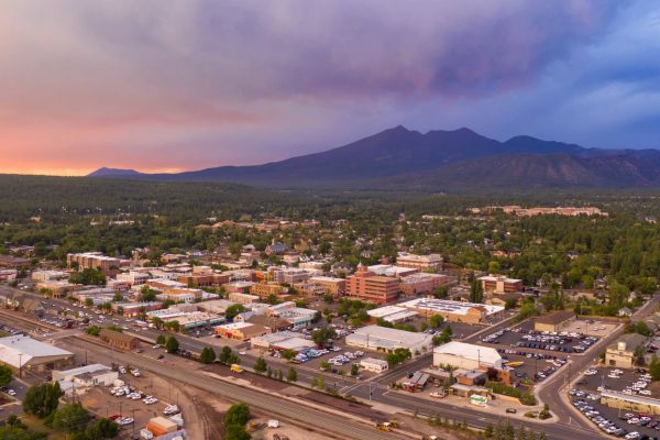 Blue and Orange color swirls around in the clouds at sunset over Flagstaff Arizona